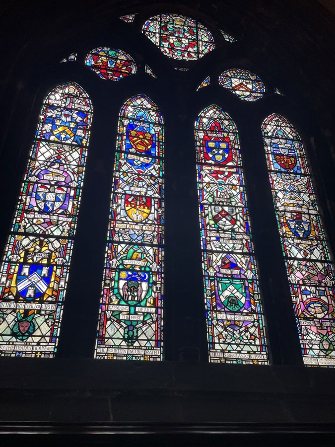 A stain-glass window in Glasgow Cathedral honors donations from various groups of laborers and trades.