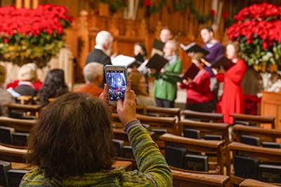 A visitor takes a photo at the Christmas Open House