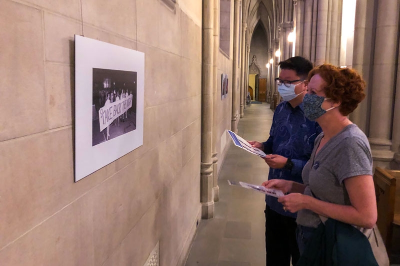 Graduate student Hananiel Setiawan (left) and Lutheran campus pastor Rev. Amanda Highben view a photograph in the exhibition.