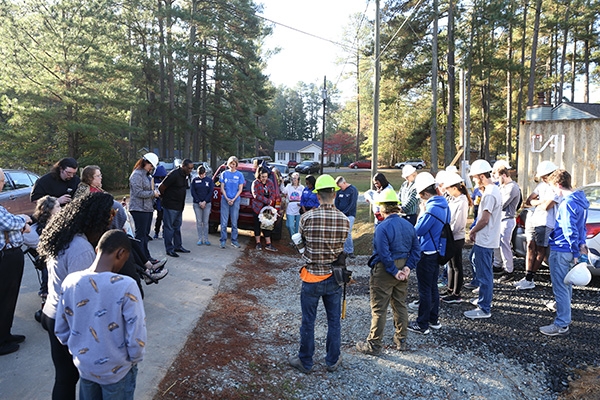 Duke and community volunteers gather to celebrate and bless a Habitat for Humanity house