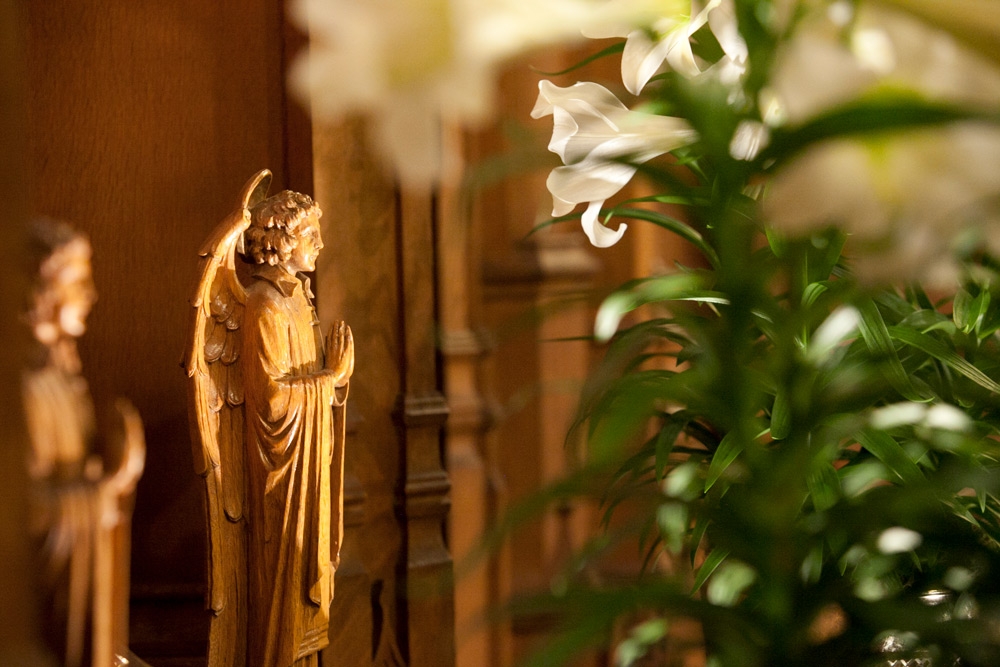 Easter lilies and angel statue