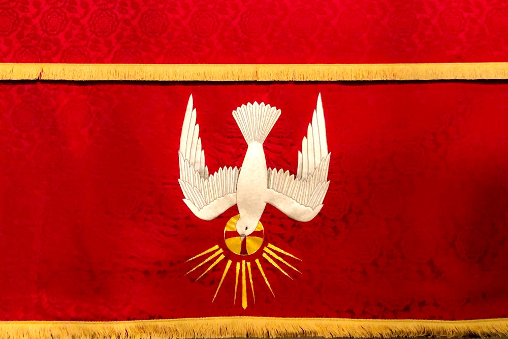 Red frontal cloth with white embroidered dove descending