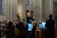 Dr. Philip Cave conducts musicians at a Bach Cantata concert.