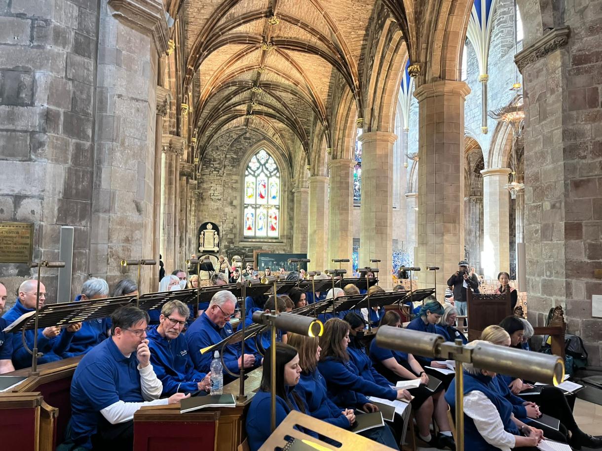 Choir members sitting in St. Giles' Cathedral while on tour in Scotland.